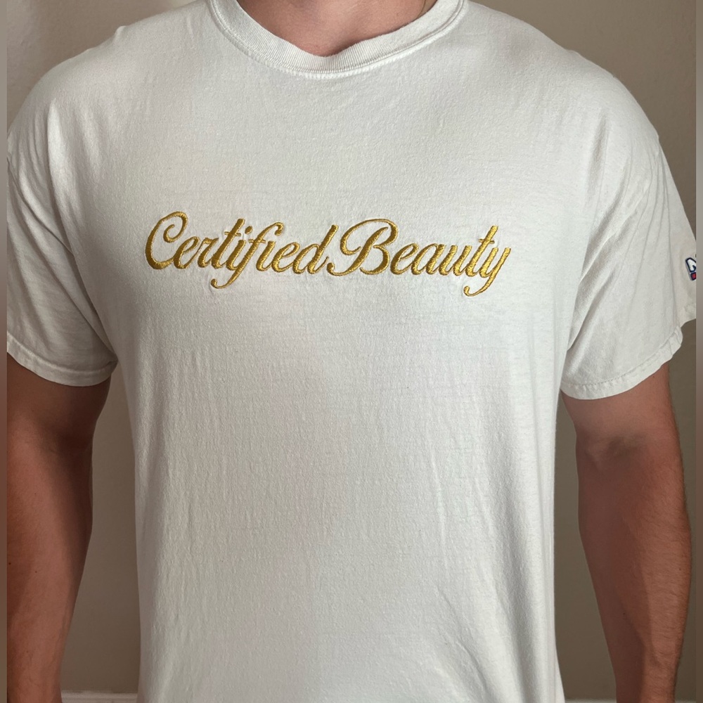 Men’s white novelty T-shirt with Certified Beauty gold embroidered